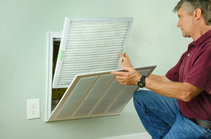 A person changing an air filter