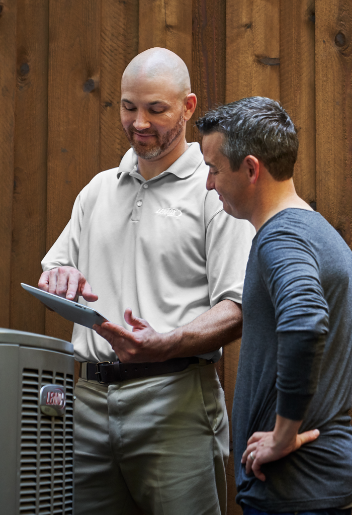 Lennox HVAC technician working with a customer