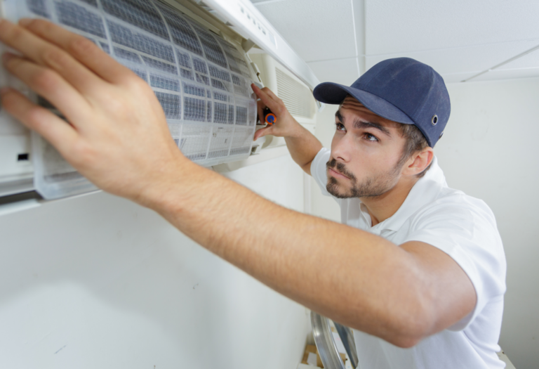 A technician installing a new, clean AC filter.