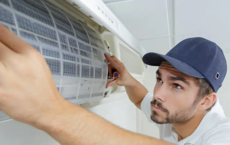 Hand changing an air conditioning unit filter.
