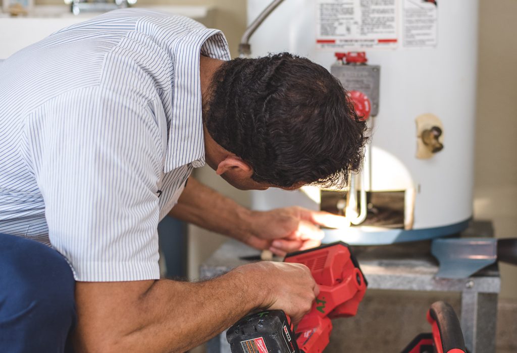 technician performing plumbing maintenance service