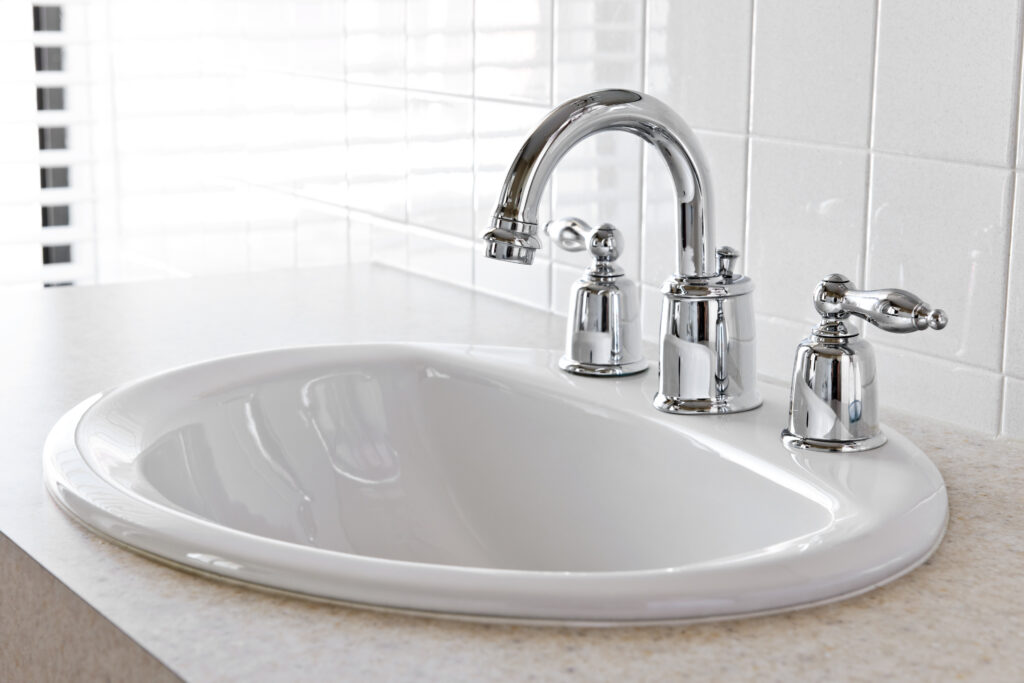 Bathroom interior with white sink and faucet