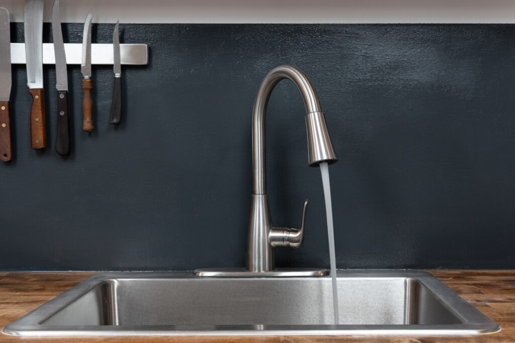 Dish sink with running water in a chef's kitchen