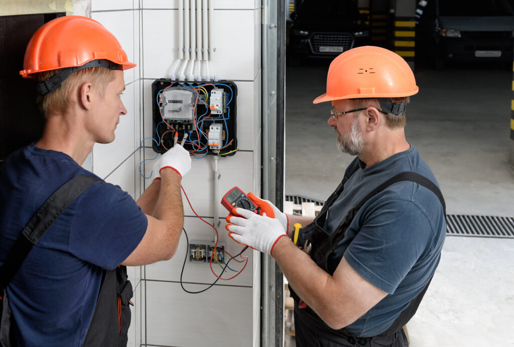Technicians assessing an electrical system