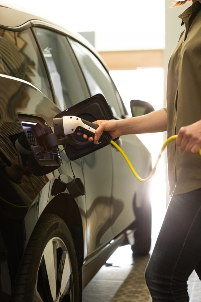 A person plugging their car into an EV charger