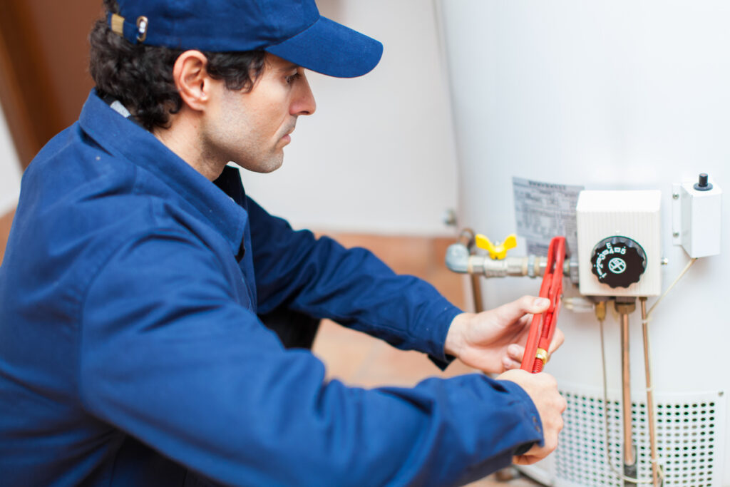 A plumber fixing a water heater