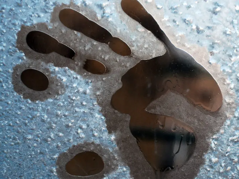 handprint on icy window